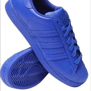 Royal blue Pharrell x Adidas Superstar sneakers